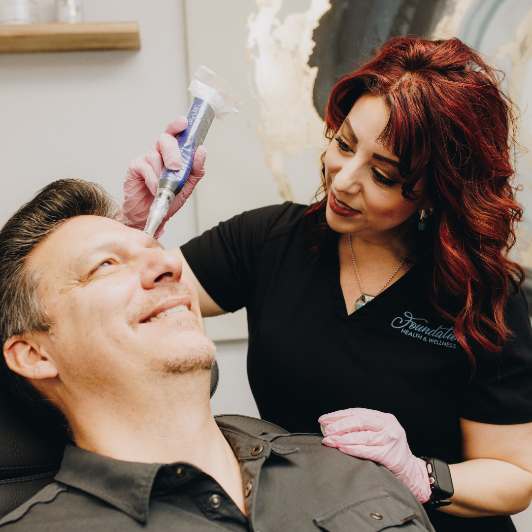 Male patient receiving a SkinPen treatment on his face.